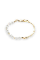 Close-up shot of a young European woman wearing a stylish bracelet decorated with pearl beads on a green background. A bracelet with pearls is on a woman's hand. Front view.