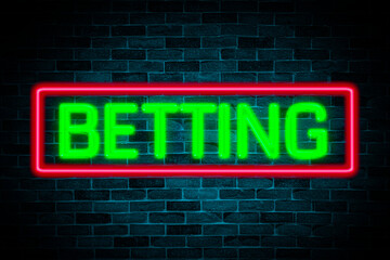 Betting text neon banner on brick wall background.