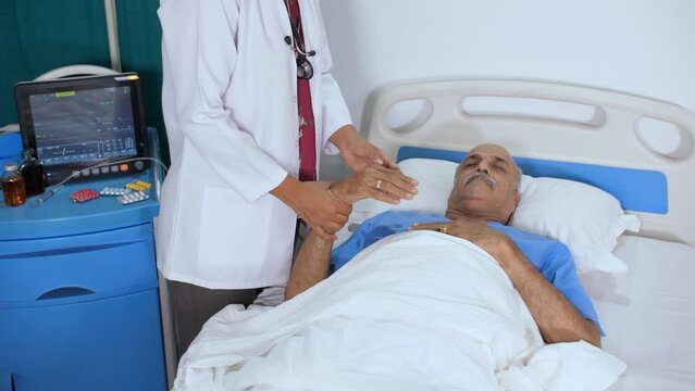 A female medical worker is checking the pulse and breath of an elderly person - unresponsive  unconscious  dead body. A nurse covering a deceased person with white hospital sheet - hospital mortali...