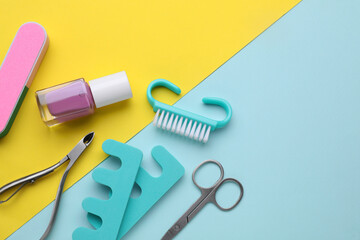 Set of pedicure tools on color background, flat lay. Space for text