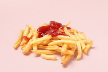 Tasty french fries with ketchup on pink background, closeup