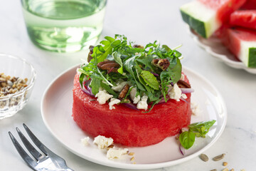 watermelon steak with feta cheese, greens and nuts