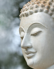 Close-up face of a white stone Buddha