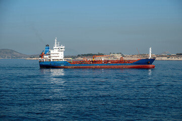 Container cargo ship loaded leaves Piraeus port, Greece. Import export business and logistics.
