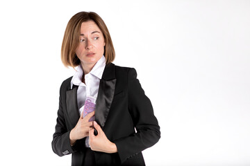 Close-up photo of cunning businesswoman hiding pack of cash money in her jacket isolated on white...