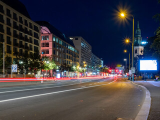 Fototapeta premium View of the night streets of Berlin and the light trails left by cars. Night European city.
