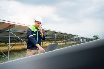 Naklejka na ściany i meble Electrical engineer working with alternative energy solar panels. Male engineer in solar power station.