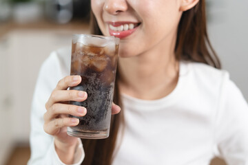 person holding a glass of soda cola