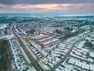Naklejka na ściany i meble Experience the raw power and serene beauty of a winter storm in Barrie, Ontario through captivating drone views. This stunning footage captures the icy transformation of the landscape, as snow blanket