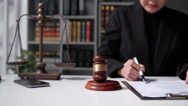 lawyer working with contract papers and wooden gavel on tabel in courtroom. justice and law ,attorney, court judge, concept.
