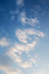Blue sky with soft white clouds.