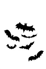 Bats made of black paper on a white background. Halloween crafts - black bats. DIY bats for Halloween.