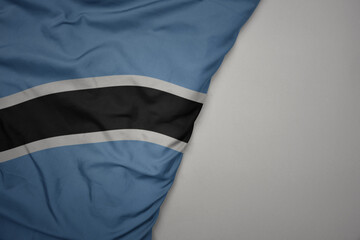 big waving national colorful flag of botswana on the gray background.