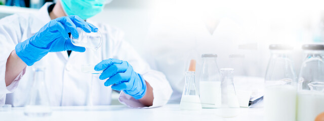 Science banner or background of nutritionist test milk delves quality analysis in laboratory of...