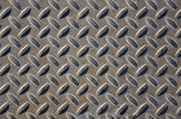 Closeup of textures and patterns on a manhole cover

