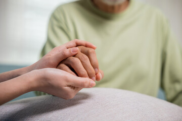 Closeup hand. Young woman helping hold hands offering her senior man, Caring nurse helping elderly...