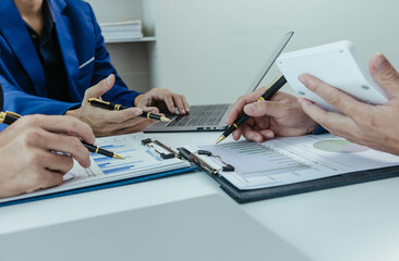 Close up of a team of business people having a meeting to analyze data for a marketing plan.	