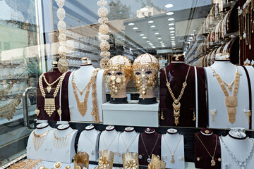 Golden shop window display traditional arabic face mask jewelry old town of Jeddah Saudi Arabia