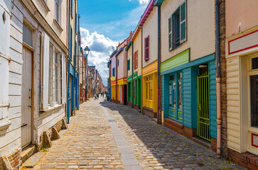 Cityscape of Amiens historical city centre Saint-Leu quarter. Colorful houses and multicolored buildings on narrow street of old town in France, France landmarks, Hauts-de-France Region, France - obrazy, fototapety, plakaty