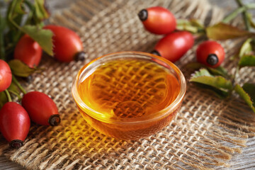 Red rosehip seed oil with fresh rosehip berries