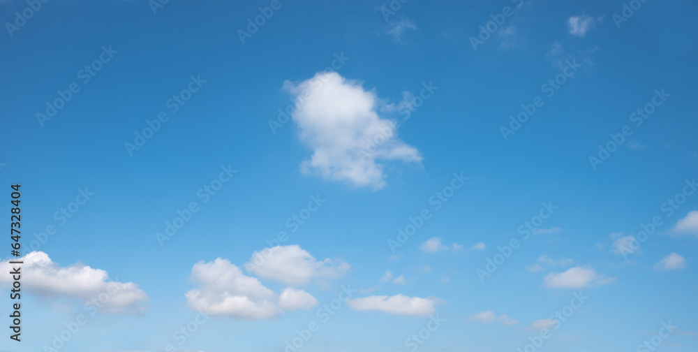 Wall mural soft sky panorama with floating clouds, one tiny cloud in the middle