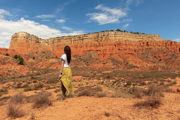 Woman walking through the Red Canyon of Teruel, also known as Rambla de Barrachina