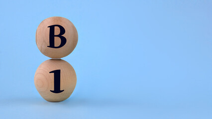 Vitamin B1 on wooden balls on a blue background