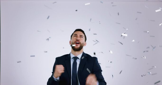 Winner, confetti for success and business man in studio for celebration of bonus, payment and deal. Reward, excited and happy person cheer for winning, promotion and lottery on white background
