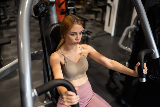 Sporty woman exercising in fitness gym