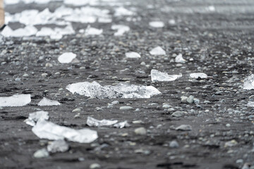 Close up of glacier ice washed ashore on a black sand beach. Diamond Beach, Iceland