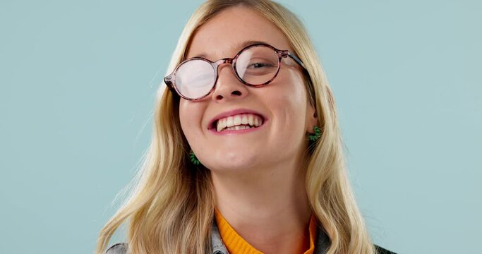 Face, smile and woman with glasses, health and clear vision on a blue studio background. Portrait, person and model with eyewear, Canada and optometry with retina, wellness and frame with happiness