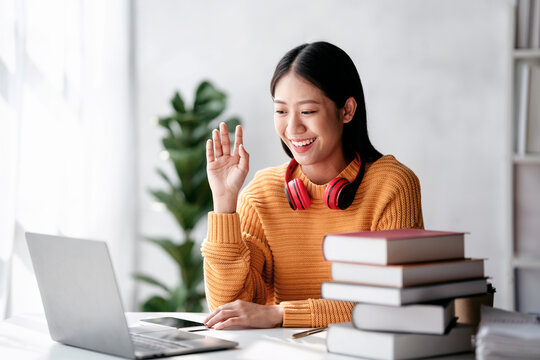 Distance education learning concept, Young woman in sweater studying education lesson online and greeting