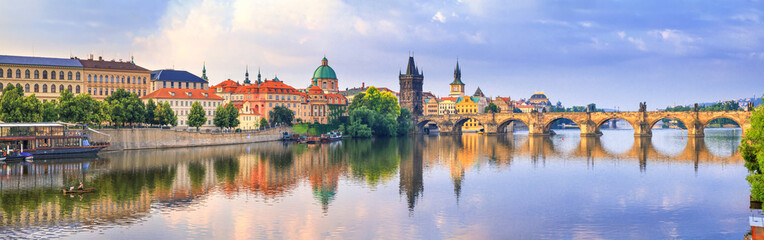 City summer landscape at sunrise, banner - view of the Charles Bridge and the Vltava river in the...