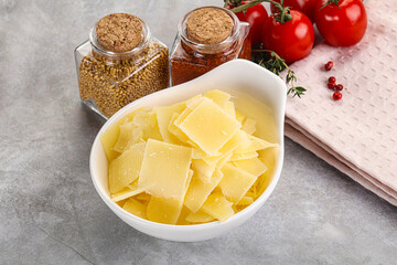 Sliced parmesan cheese in the bowl