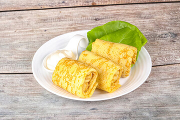 Stuffed pancakes with cream sauce