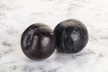 Two ripe sweet black plums
