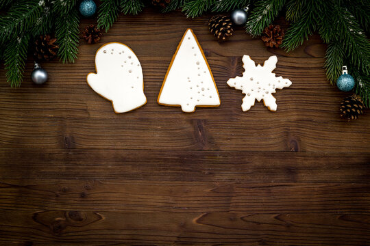 White Christmas gingerbread cookies with fir tree branches. New Year background