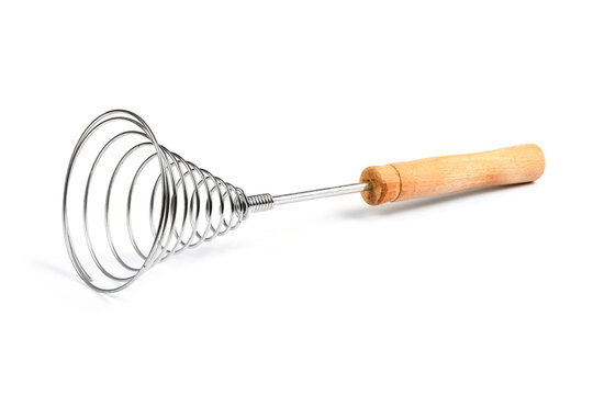 Close-up of old retro whisk kitchen tool on white background. Side view.