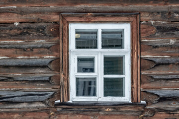 Old rectangular window with a white frame in an old log house. From the series Window of the World.