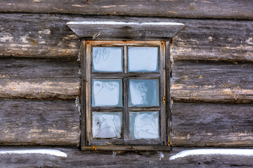 Old rectangular window with a wooden frame in an old log house. From the Windows of the world series.