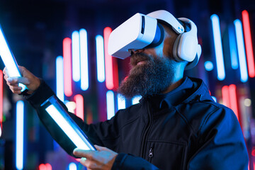 Man in futuristic costume. Guy in glasses of virtual reality while touching air. Augmented reality...