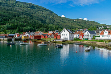 Fototapeta na wymiar Solvorn, Norway: small village on a fjord with typical colored wooden houses
