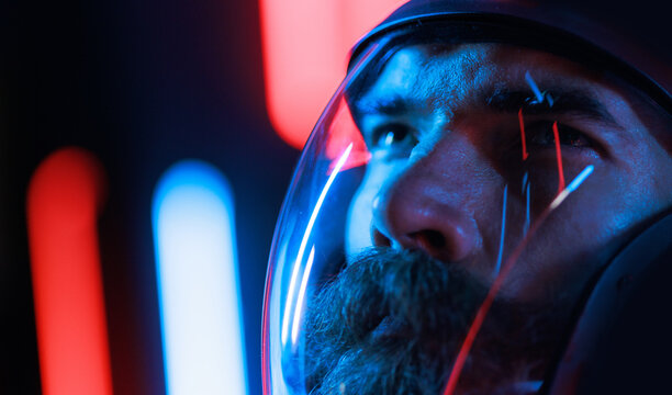 Portrait of futuristic astronaut.  conception. Augmented reality game, future technology, astronomy, AI concept. Neon blue and red light. Dark background.