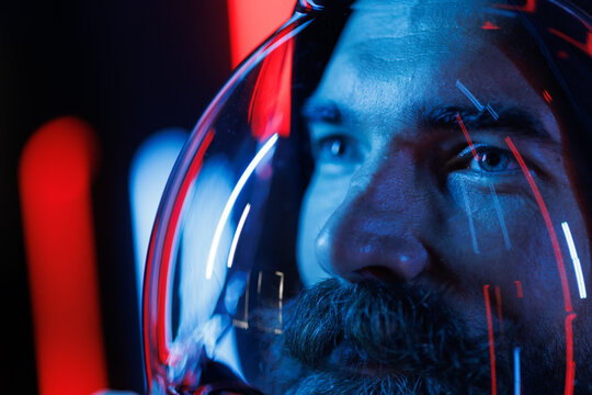 Portrait of futuristic astronaut.  conception. Augmented reality game, future technology, astronomy, AI concept. Neon blue and red light. Dark background.