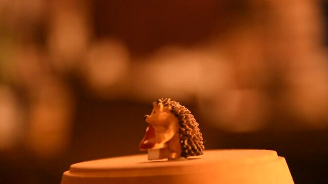 Little hedgehog miniature rotating in warm night light lamp autumn decoration