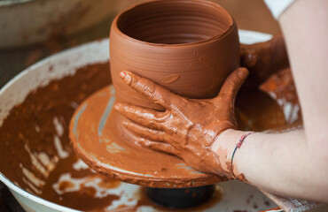 Ceramist molding a vase on the potter's wheel