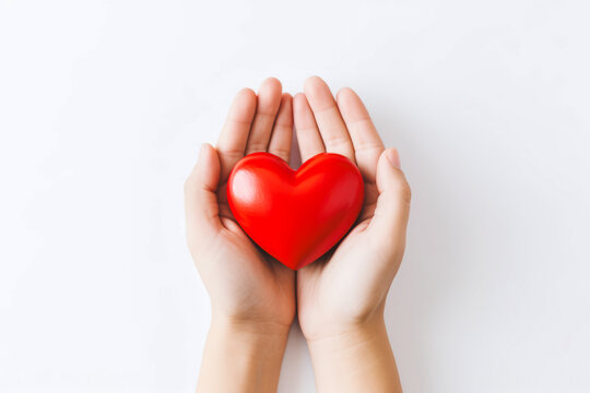 a pair of hands holding a red heart in white background