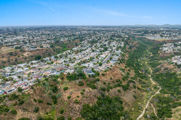 Fototapeta na wymiar Aerial view of house in Serra Mesa City in San Diego, California, USA. Green Dry Valley and Villas