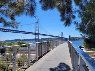 The 25 de Abril bridge over the Tajo River with Cristo Rei or Christ the King in the background....