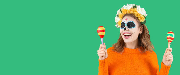 Happy woman with painted skull on face and maracas on green background with space for text. Mexico's Day of the Dead (El Dia de Muertos)